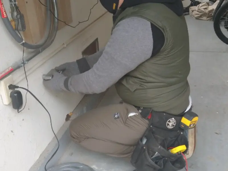 Electrician performing outlet wiring in a Fruita garage